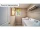 A compact laundry room with white washer and dryer units and a window for natural light at 4266 Sylvan Pond Ct, Denver, NC 28037