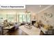 Spacious living room featuring large windows, ceiling fan, fireplace and stylish furniture at 4266 Sylvan Pond Ct, Denver, NC 28037