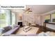 Cozy living room with a fireplace, ceiling fan, and an abundance of natural light at 4266 Sylvan Pond Ct, Denver, NC 28037