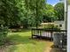 Spacious backyard with a wooden deck, bordered by lush trees, offering a private retreat at 4333 Dunwoody Dr, Charlotte, NC 28215