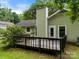 Backyard featuring a wooden deck, siding and a chimney, surrounded by lush greenery at 4333 Dunwoody Dr, Charlotte, NC 28215