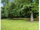 Expansive backyard with well-maintained lawn, mature trees, and a sense of natural tranquility at 4333 Dunwoody Dr, Charlotte, NC 28215