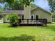 The backyard features a wooden deck, lush lawn and convenient access to the home's exterior at 4333 Dunwoody Dr, Charlotte, NC 28215