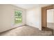 Carpeted bedroom with a bright window and doorway, offering natural light at 4333 Dunwoody Dr, Charlotte, NC 28215
