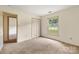 Bedroom with carpet, neutral walls, a window, and a closet with folding doors at 4333 Dunwoody Dr, Charlotte, NC 28215