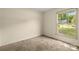Bedroom featuring neutral walls, carpet and a window showcasing a green yard at 4333 Dunwoody Dr, Charlotte, NC 28215