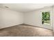 Bright bedroom featuring neutral walls, carpet and a large window overlooking a wooded area at 4333 Dunwoody Dr, Charlotte, NC 28215