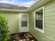 Side view of home displaying siding, white trim windows and door, and outdoor lighting fixtures at 4333 Dunwoody Dr, Charlotte, NC 28215