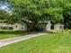 Inviting single-story home with well-maintained lawn, long driveway, and convenient storage shed at 4333 Dunwoody Dr, Charlotte, NC 28215