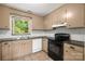 The kitchen has tile floors, updated countertops, modern appliances, a window, and ample cabinet space at 4333 Dunwoody Dr, Charlotte, NC 28215