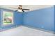 Bedroom featuring blue walls and soft white carpet with a bright window to the outside at 439 Neisler Rd, Concord, NC 28025