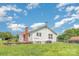 Exterior of a home with white siding and a red roof with a backyard and fence at 439 Neisler Rd, Concord, NC 28025