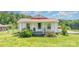 Charming single-story home with white siding, red metal roof, and cozy front porch at 439 Neisler Rd, Concord, NC 28025