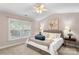Comfortable bedroom featuring a ceiling fan, bedside tables, and a decorative headboard at 4442 Coventry Row Ct, Charlotte, NC 28270