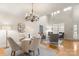 Elegant dining area featuring a chandelier and hardwood floors at 4442 Coventry Row Ct, Charlotte, NC 28270