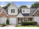 Charming townhome with a well-manicured lawn, brick accents, and attached garage at 4442 Coventry Row Ct, Charlotte, NC 28270