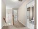 Upstairs hallway with neutral carpet and open doorways to various rooms, including a bathroom at 4442 Coventry Row Ct, Charlotte, NC 28270