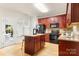 Well-equipped kitchen with dark wood cabinets and modern appliances at 4442 Coventry Row Ct, Charlotte, NC 28270