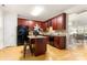 This kitchen features wood floors, an island, and cherry cabinets offering a blend of style and functionality at 4442 Coventry Row Ct, Charlotte, NC 28270