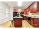 Kitchen with a center island, dark wood cabinets, and hardwood floors at 4442 Coventry Row Ct, Charlotte, NC 28270
