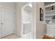 Bright laundry area with modern machines and built-in shelving for organized storage at 4442 Coventry Row Ct, Charlotte, NC 28270