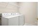 Well-lit laundry room featuring side-by-side washer and dryer units at 4442 Coventry Row Ct, Charlotte, NC 28270