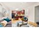 The comfortable living room leads to the kitchen with cherry cabinets and an island creating a seamless flow at 4442 Coventry Row Ct, Charlotte, NC 28270