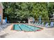 Community pool surrounded by trees and lounge chairs at 4442 Coventry Row Ct, Charlotte, NC 28270