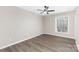 This bedroom has hard surface floors, a ceiling fan, and a window to let in natural light at 4601 Coronado Dr, Charlotte, NC 28212
