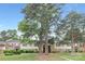 Traditional two-story townhomes with brick and siding exteriors surrounded by mature shade trees at 4601 Coronado Dr, Charlotte, NC 28212