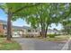 The exterior of these townhomes is brick and siding with mature trees and a paved driveway at 4601 Coronado Dr, Charlotte, NC 28212