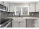Kitchen featuring stainless steel appliances, grey subway tile backsplash and granite countertops at 4601 Coronado Dr, Charlotte, NC 28212
