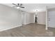Neutral living room with hard wood flooring and modern light fixture at 4601 Coronado Dr, Charlotte, NC 28212