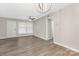 Neutral living room featuring hardwood flooring, ceiling fan, and a modern light fixture at 4601 Coronado Dr, Charlotte, NC 28212