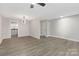 Neutral living room with hardwood flooring and modern light fixture at 4601 Coronado Dr, Charlotte, NC 28212
