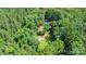 Secluded home nestled among mature trees, offering privacy and a connection with nature at 500 Mount Pleasant N Rd, Mount Pleasant, NC 28124