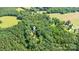 Aerial view with locator pin indicates the home's location among a wooded landscape at 500 Mount Pleasant N Rd, Mount Pleasant, NC 28124