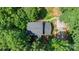 Aerial view showcases the home's roof and its private setting surrounded by mature trees at 500 Mount Pleasant N Rd, Mount Pleasant, NC 28124
