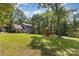 Spacious yard with mature trees and a charming playset, perfect for outdoor Gathering fun at 500 Mount Pleasant N Rd, Mount Pleasant, NC 28124
