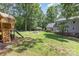 Backyard with playground, seating, and home at 500 Mount Pleasant N Rd, Mount Pleasant, NC 28124