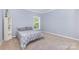 This bedroom features neutral paint, carpet, and one window for plenty of natural light at 500 Mount Pleasant N Rd, Mount Pleasant, NC 28124