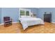 Bedroom featuring a bright window, hardwood floors, and simple decor at 500 Mount Pleasant N Rd, Mount Pleasant, NC 28124