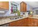 Well-lit kitchen featuring granite countertops and ample cabinet space with garden view at 500 Mount Pleasant N Rd, Mount Pleasant, NC 28124