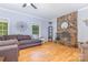 Inviting living room with stone fireplace, hardwood floors, and abundant natural light at 500 Mount Pleasant N Rd, Mount Pleasant, NC 28124