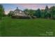 Expansive green lawn and landscaping create a private retreat surrounding this elegant estate at 5112 Mill Race Ln, Lancaster, SC 29720