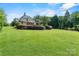 Lush green lawn and manicured landscaping surrounding an estate, creating a serene and private outdoor space at 5112 Mill Race Ln, Lancaster, SC 29720