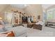 Spacious bonus room with comfortable sofas, ottomans, and neutral carpet and paint at 5112 Mill Race Ln, Lancaster, SC 29720