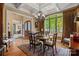 Formal dining room with coffered ceilings, chandelier, hardwood floors, and large arched window with curtains at 5112 Mill Race Ln, Lancaster, SC 29720