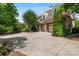 A grand estate with a spacious driveway, multiple car garage, and well maintained landscaping at 5112 Mill Race Ln, Lancaster, SC 29720