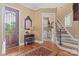 Inviting foyer features wood floors, a decorative door, a mirror, and a view of the staircase at 5112 Mill Race Ln, Lancaster, SC 29720